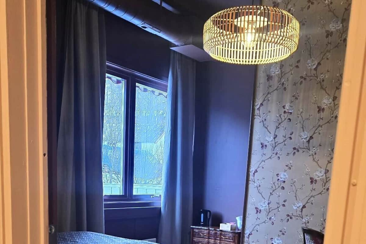 Desk, laptop workspace, blackout drapes, bed sheets