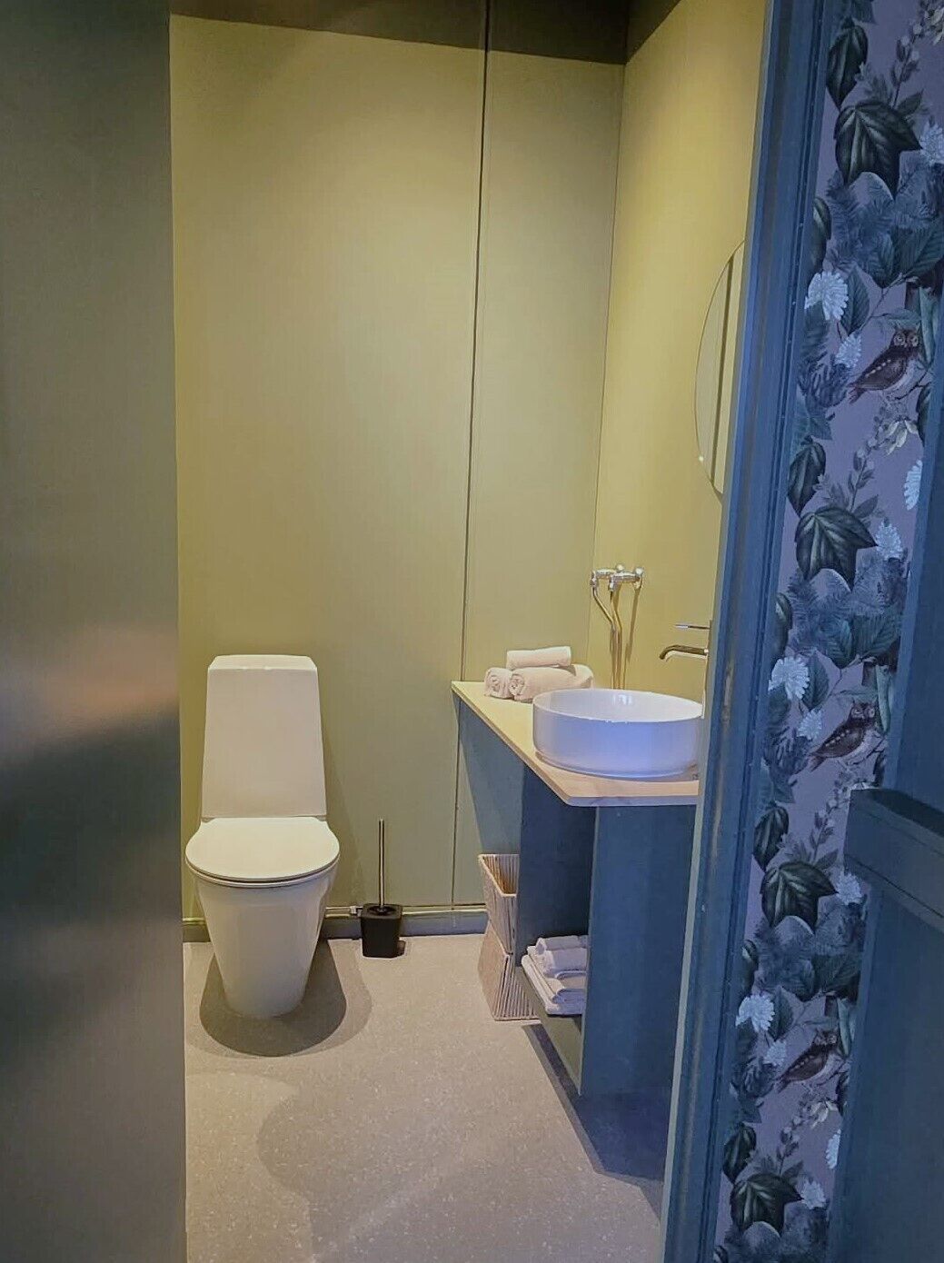 A compact bathroom with a toilet, a sink, and a shower area.