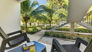 Een overdekt terras met rieten meubels, een tafel en een boek.