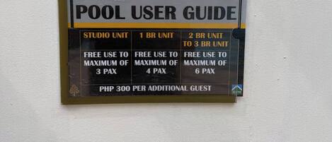 A pool user guide sign with information on different pool unit sizes and their respective free use limits.