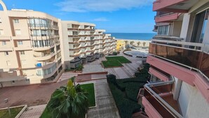 A multi-story hotel with balconies, a central courtyard, and a view of the beach. - Canet-en-Roussillon T2 Beachfront with Parking - Perfect for 4 (Canet-en-Roussillon)