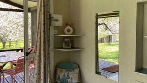 A room with a window, a mirror, a shelf with a vase and picture frame, and a chair. - Comfortable 2-Bedroom Chalet with Terrace in Vébron (Vebron)
