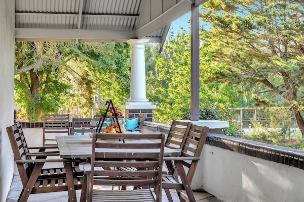 The wide wraparound verandah is ideal for outdoor dining, morning coffee or sunset drinks overlooking the lush surrounds.