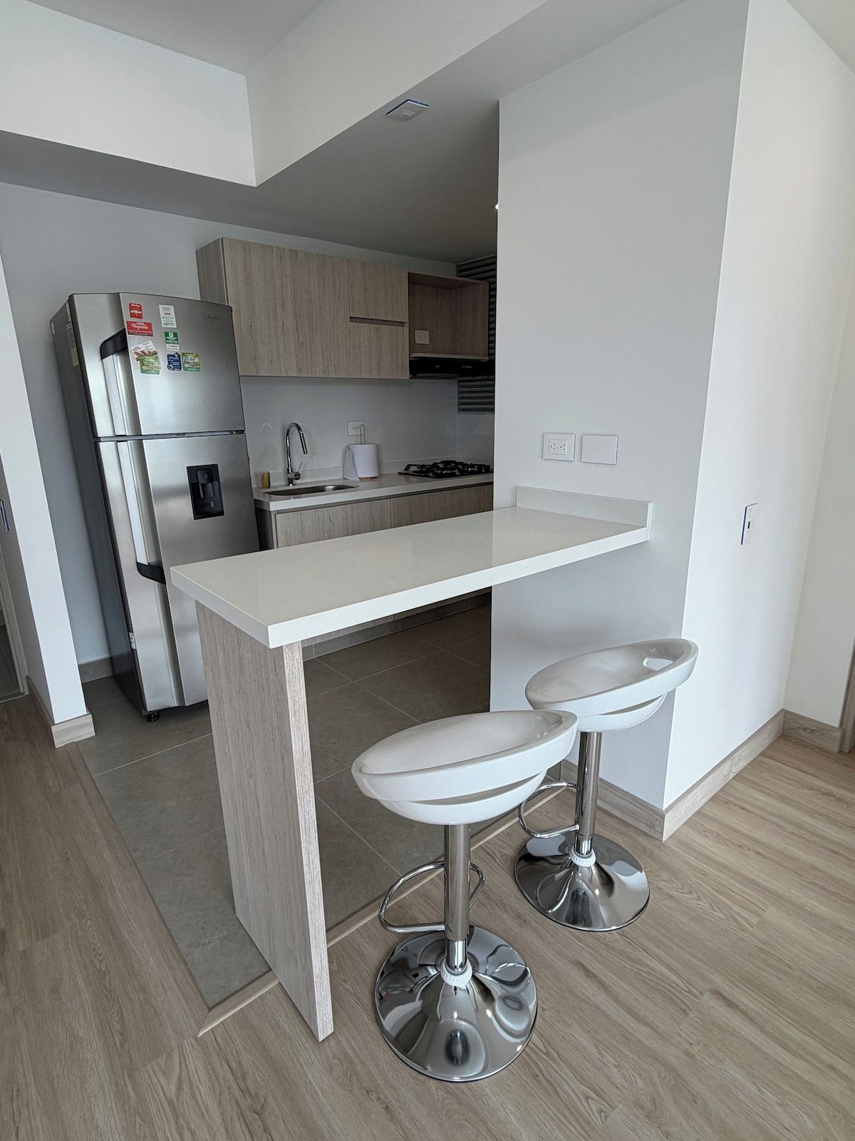 A modern kitchen with a central island, stainless steel appliances, and a minimalist design.