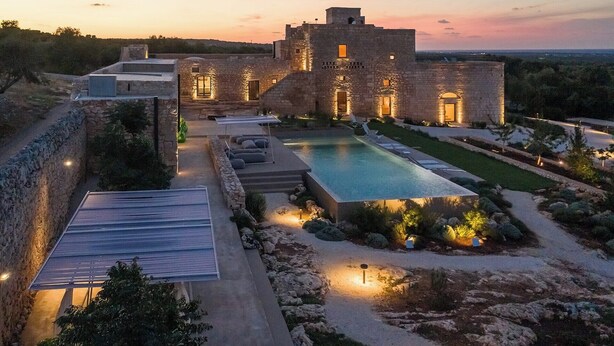 A large stone building with a swimming pool and a covered patio area. - Masseria Belvedere - Eight Bedroom Villa, Sleeps 16 (Carovigno)