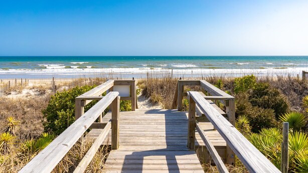 A wooden boardwalk leading to a beach with clear skies. - Sunny Bungalow Retreat w/Pool + 6 Person Golf Cart Included (Emerald Isle)