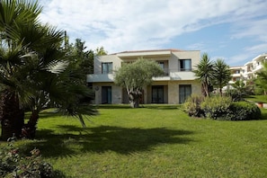 A modern two-story building with a flat roof and a balcony on the second floor. - Renaissance Hanioti Resort (Kassandra)