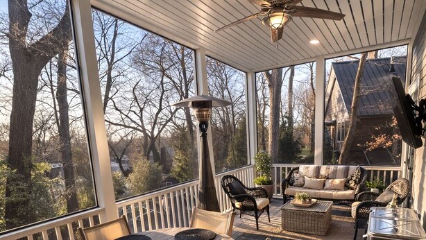 A covered outdoor deck with a wooden table and chairs, a ceiling fan, and a grill. - Upscale 5BR House in Morningside – Perfect for World Cup Groups (Atlanta)