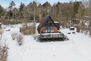 A modern cabin with a sloped roof, large windows, and a deck. - Holiday home near beach and Limfjord (Thyholm)