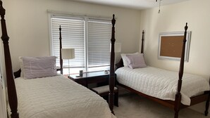A bedroom with two wooden four-poster beds, a desk, and a chair. - Available Masters! Only 2.2 miles from the course. (Augusta)