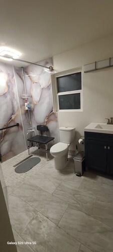 A cozy place with a wheelchair accessible shower and adjustable beds