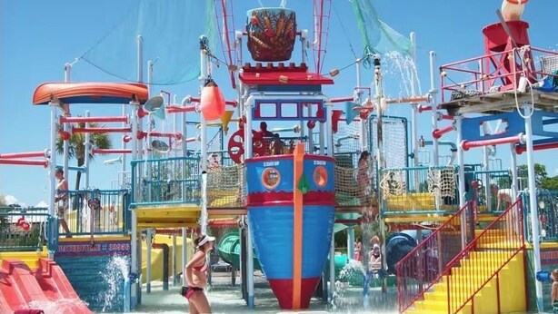 A water park with a large ship-themed play structure, slides, and a pool area. - 7029- Family Friendly - Gulf Shores - Pools-beach (Gulf Shores)