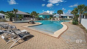 A swimming pool with lounge chairs, a small deck, and a clear blue sky. - 7029- Family Friendly - Gulf Shores - Pools-beach (Gulf Shores)