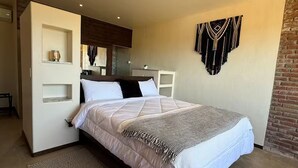 Une chambre moderne avec un grand lit, un bureau intégré et une décoration murale.