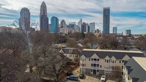 A residential area with a mix of modern and traditional buildings, including a prominent tall skyscraper in the background. - The Orange Luxe Modern 2bdrm Retreat in Uptown Charlotte ( (Charlotte)