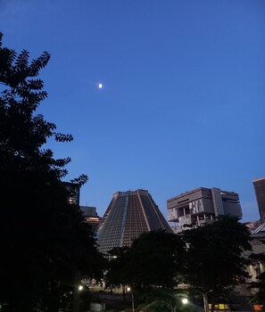 A cityscape with a prominent building featuring a unique triangular design, surrounded by other modern structures. - Studio 309, Lapa, close to everything that matters in Rio. Air conditioning, kitchen, and balcony! (Rio de Janeiro)