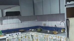 A kitchen with a gas stove, a sink, and a countertop. - Tucacas beach apartment (Tucacas)