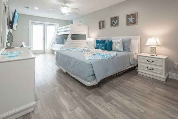A bedroom with a bunk bed, a desk, a nightstand, and a ceiling fan. - Luxury 4BR/3.5BA Coastal Retreat w/Pool --1 Block to Beach -- Sleeps 15 Guests! (Panama City)