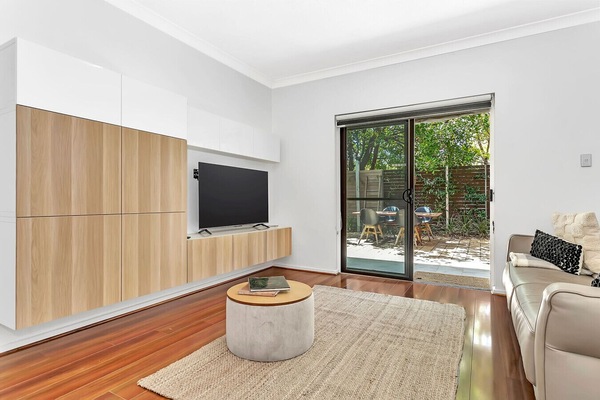 Catch up on your favourite shows in the cosy lounge, featuring sleek modern cabinetry and direct access to the courtyard.