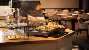 A buffet area with various food items and a coffee station. - Hotel Goryukan (Hakuba)