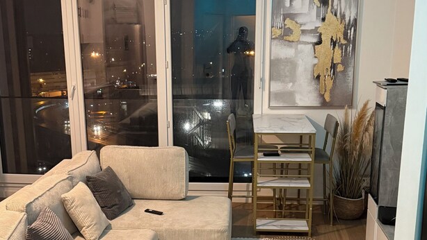 A modern living room with a sofa, coffee table, and dining area. - 2. "Comfortable stay in Bagnolet - Ideally located near the Metro" (Bagnolet)