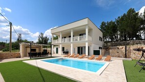 A two-story house with a swimming pool, outdoor seating, and a stone wall. - Krusevo Pool Villa For 10 (Obrovac)