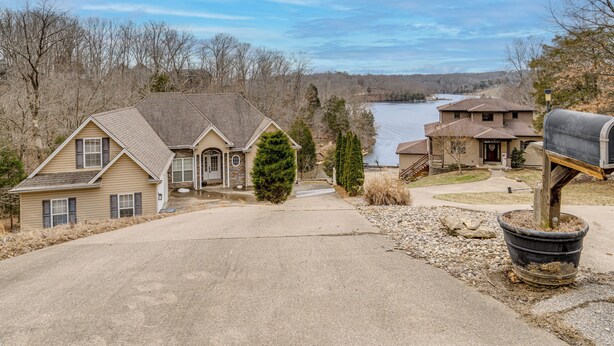 A residential area with houses, a driveway, and a mailbox. - Canoe, Swim & Hike: Lakefront Brandenburg Home! (Brandenburg)