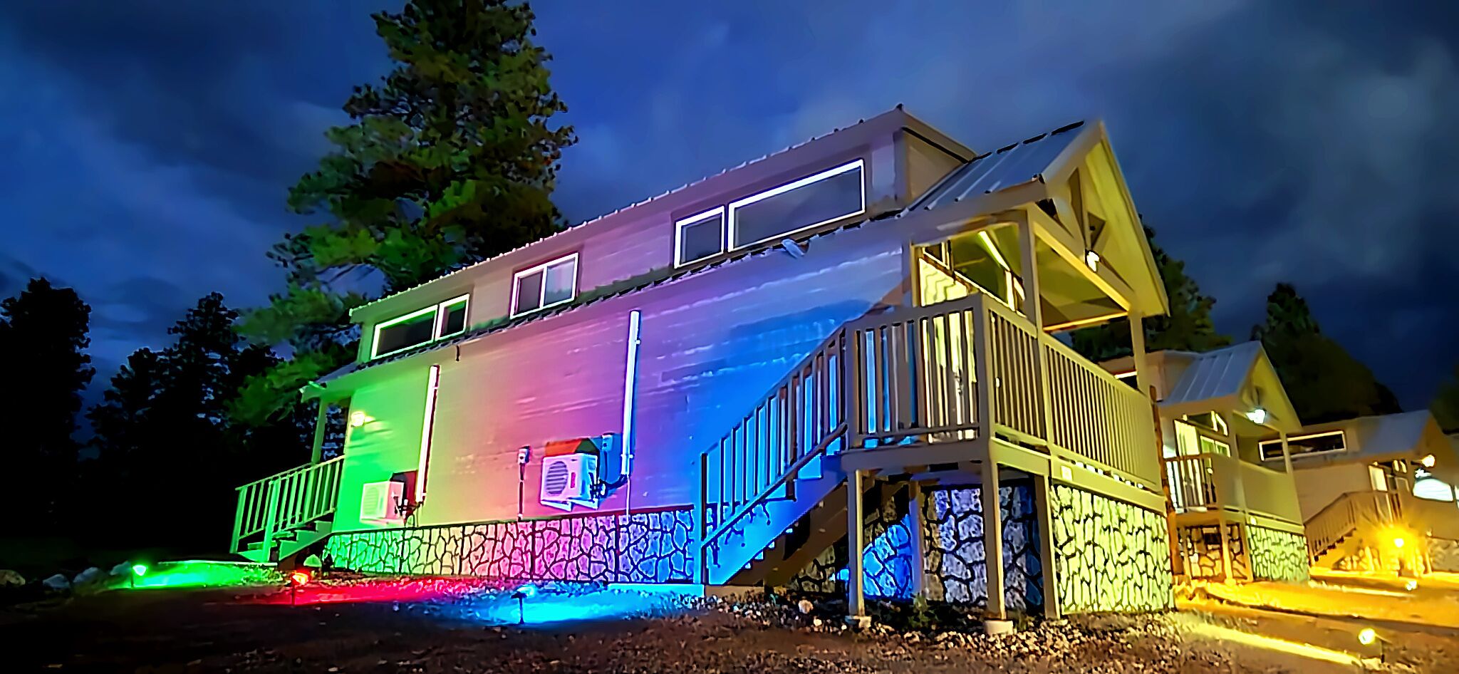 A multi-story house with a balcony and a staircase.