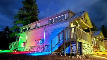 A multi-story house with a balcony and a staircase.