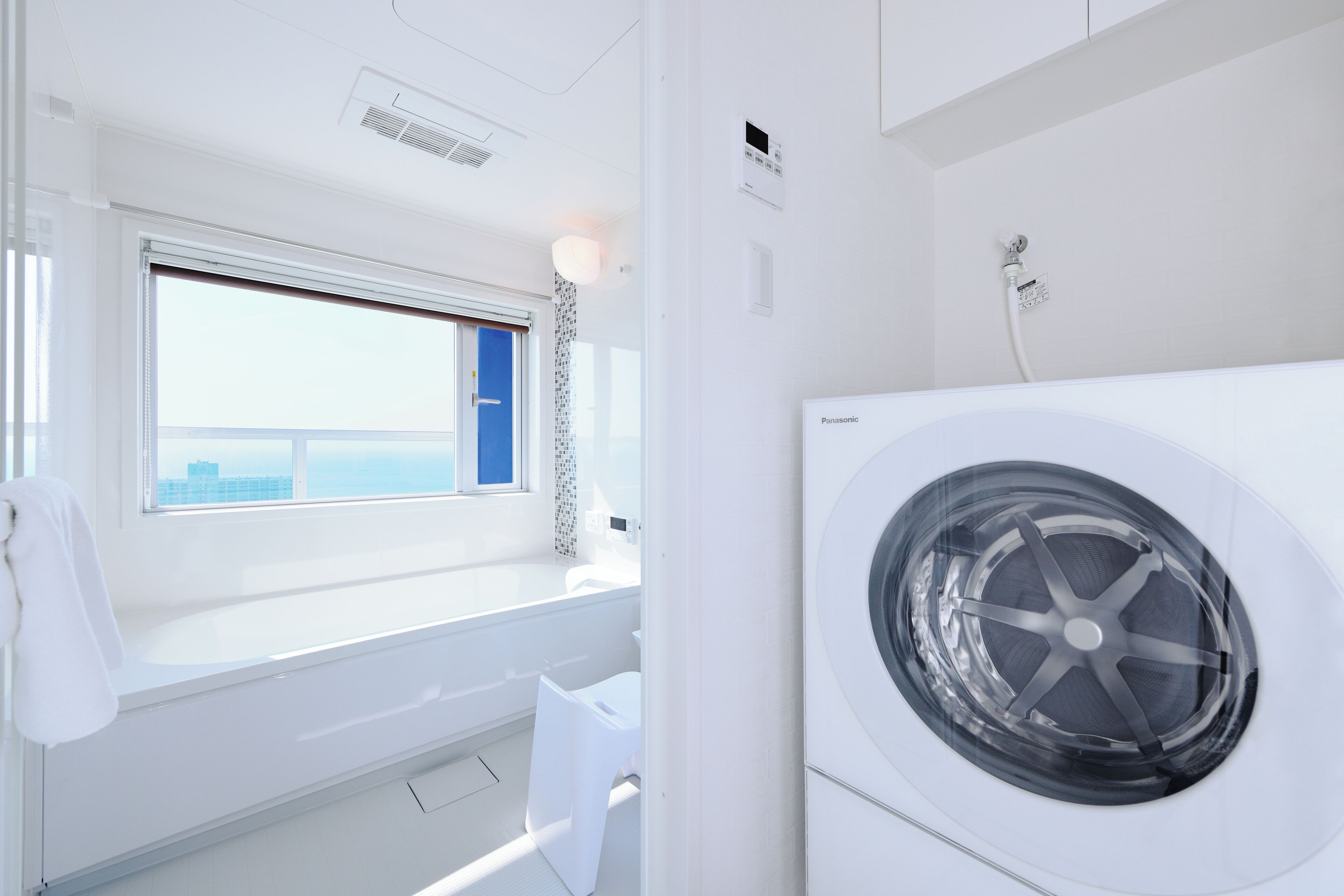 Combined shower/bathtub, hair dryer, slippers, towels