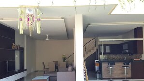 A modern living space with a sofa, coffee table, and a hanging decorative piece. - Juada Garden (Seminyak)