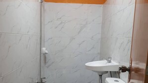 A small bathroom with a toilet, sink, and shower. - NEWLY RENOVATED ROOMS NOW OPEN FOR INQUIRIES AND RESERVATIONS (Angeles Pampanga)