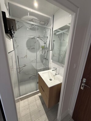 Shower, hair dryer, towels, soap