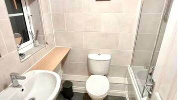 Shower, hair dryer, towels, toilet paper