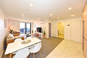 A modern apartment with a dining area, living room, and a bathroom. - Modern Manchester St Stay - 1BR with Balcony (Christchurch)