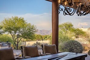 An outdoor seating area with a view of mountains and desert vegetation. - Tranquil AZ Mountain View Oasis • Pool & Fire Pit (Scottsdale)
