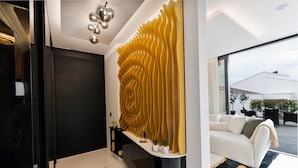 Un interior moderno con un diseño de pared curva, un sofá blanco y un gran ventanal con vistas al exterior.