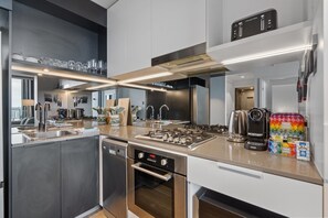 Fridge, microwave, oven, stovetop - Bright 2-Bed Apartment in Bowen Hills (Bowen Hills)
