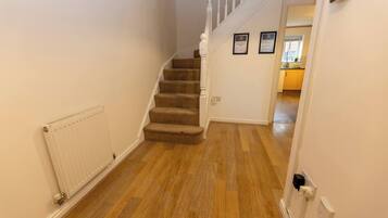 A staircase with carpeted steps leading to a second floor.