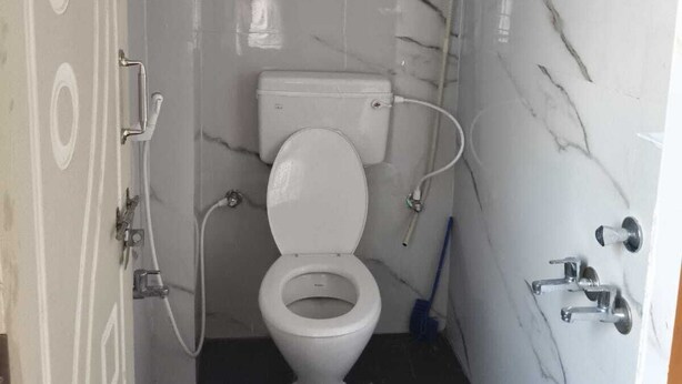 Pieni kylpyhuone, jossa on wc, suihku ja pesuallas.