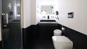 A modern bathroom with a black and white color scheme, a large mirror, a toilet, and a sink. - Vacation Home in Otranto with 1 bedrooms sleeps 2 (Otranto)