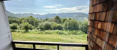 A balcony with a view of a mountainous landscape.