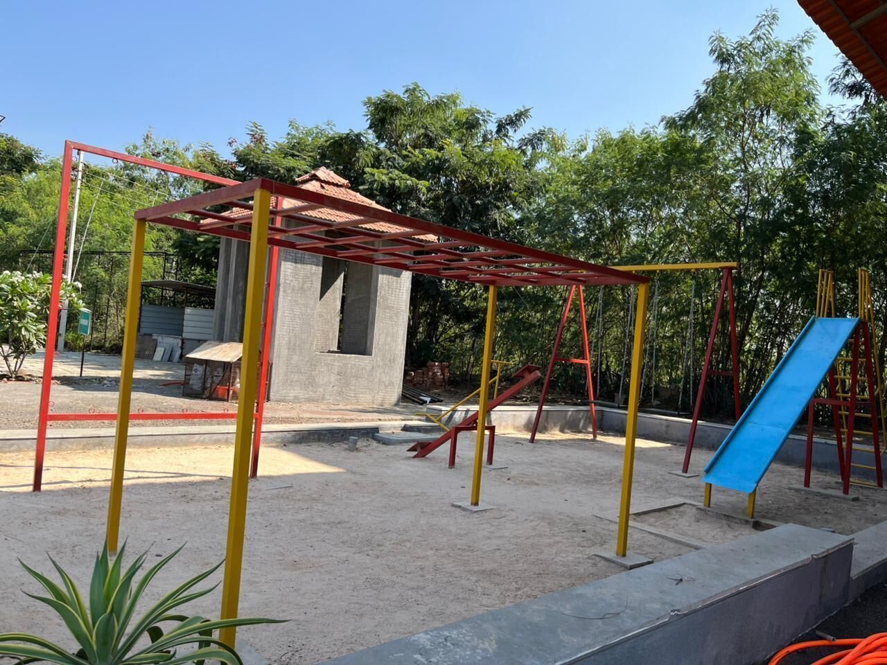 A playground with a slide and climbing structures.