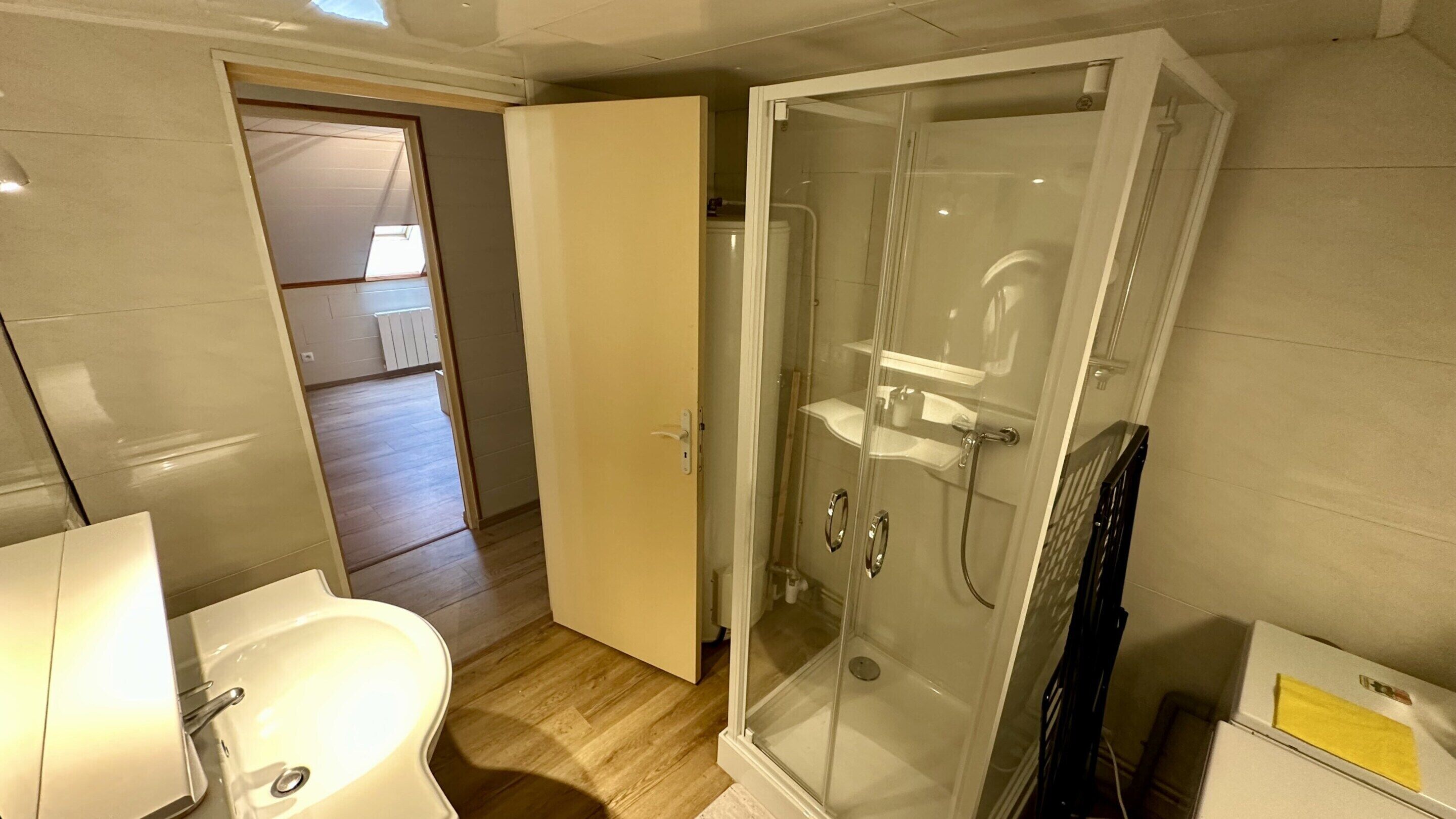 A bathroom with a shower, toilet, and sink.