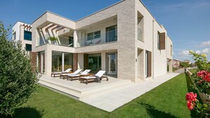 A modern two-story house with a balcony, a lawn, and a garden. - Stunning Villa With Pool in Sukosan (Sukosan)