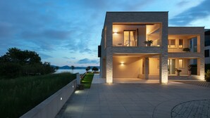 A modern two-story house with a balcony, a staircase, and a view of the sea. - Stunning Villa With Pool in Sukosan (Sukosan)