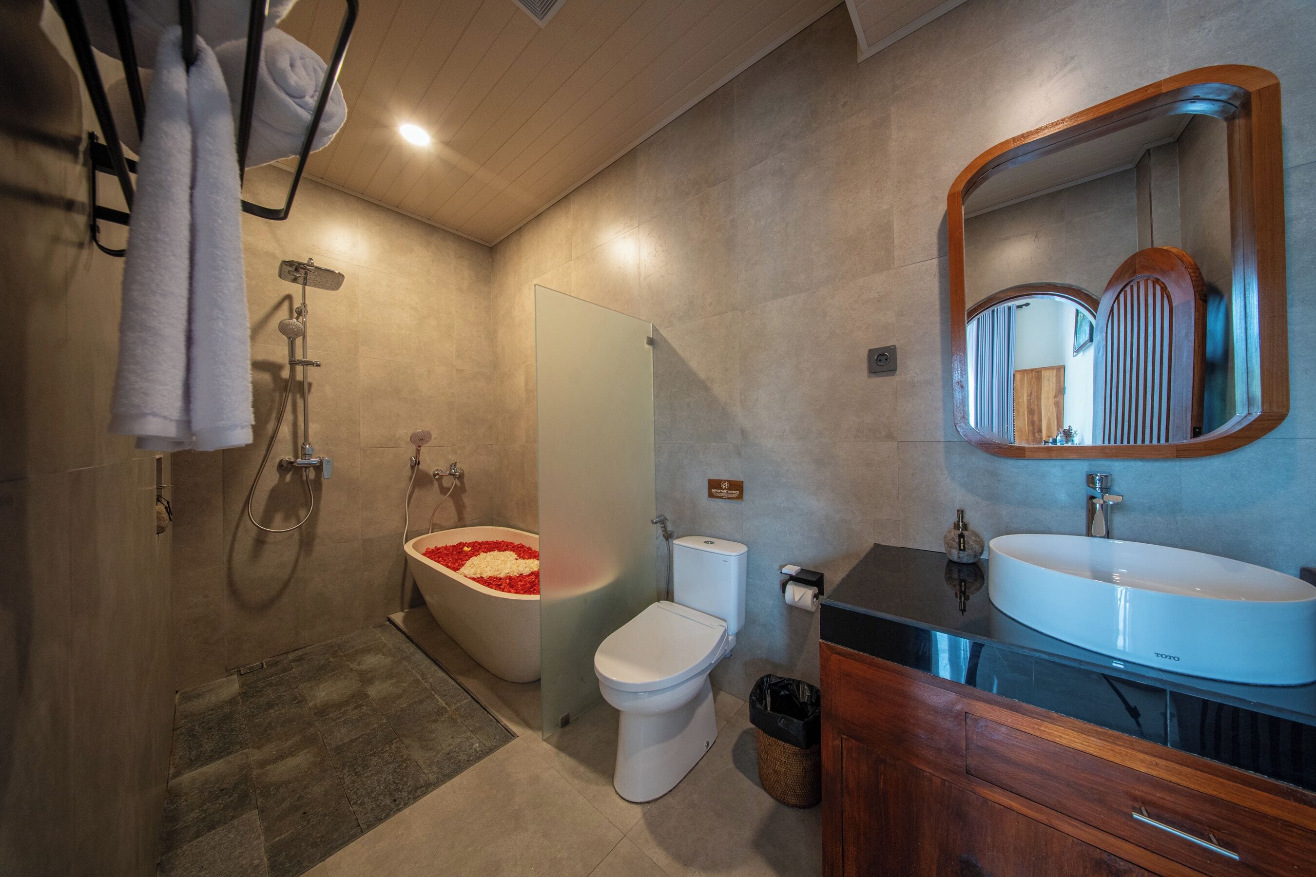 A modern bathroom with a bathtub, toilet, and sink.