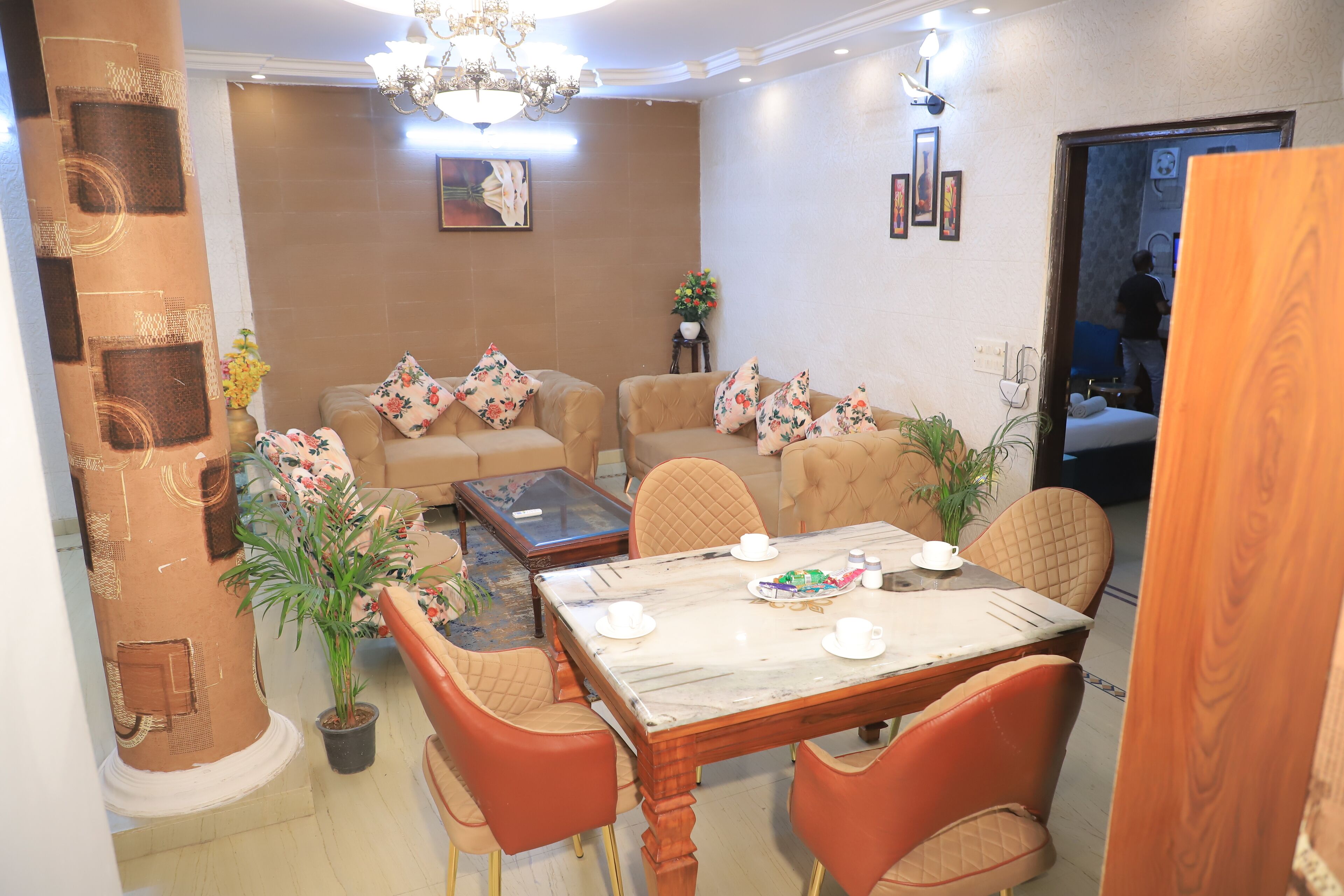 A living room with a dining table, chairs, sofas, and a coffee table.