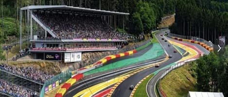 A race track with multiple lanes and a grandstand filled with spectators.