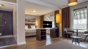 A hotel room with a bed, a desk, a chair, a TV, and a shower area. - Adventure Awaits: Free Breakfast, Parking & Outdoor Recreation Nearby (Middelburg)